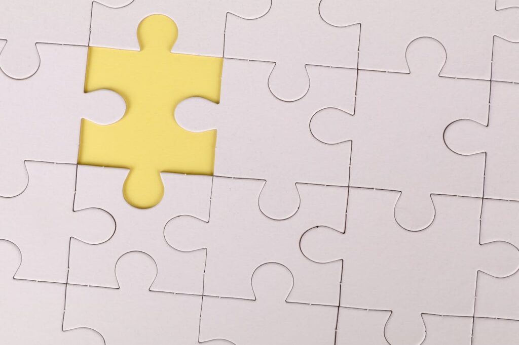 White puzzle with one piece removed